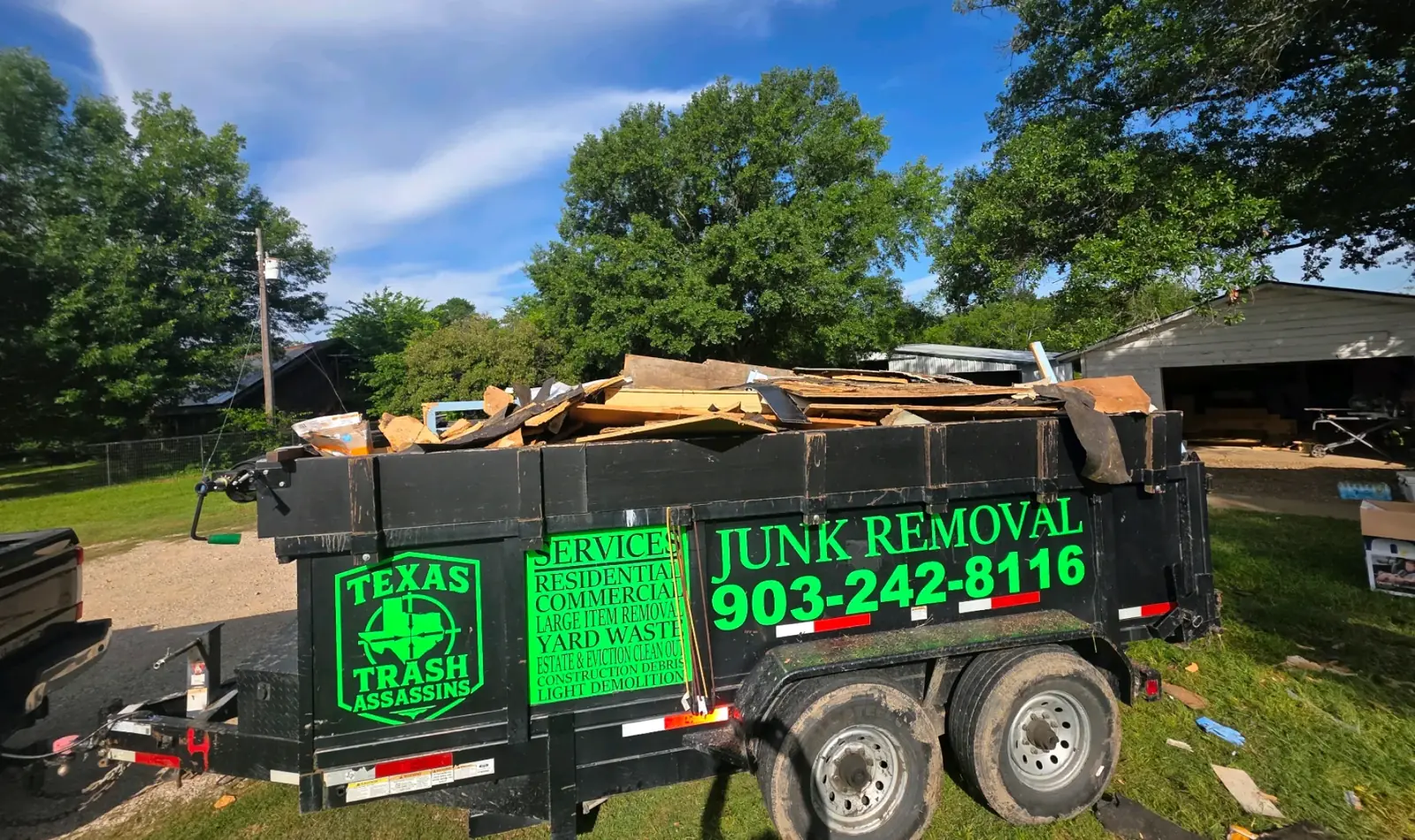 Texas Trash Assassins dump trailer loaded with junk at a customer's home