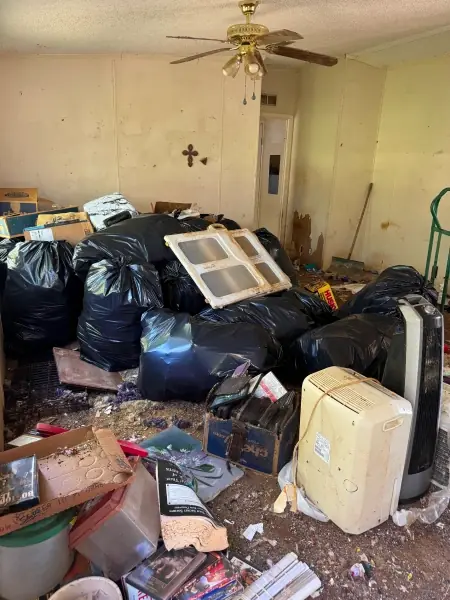 Living room filled with trash bags waiting to be hauled