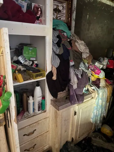 Shelves and closet crowded with belongings during a cleanout