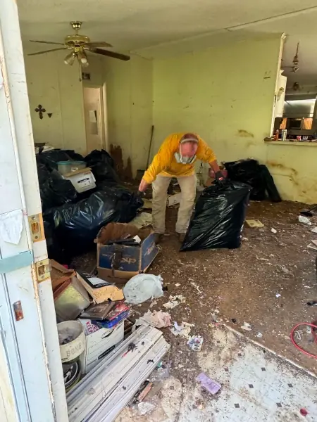 Crew member working through a heavily cluttered room