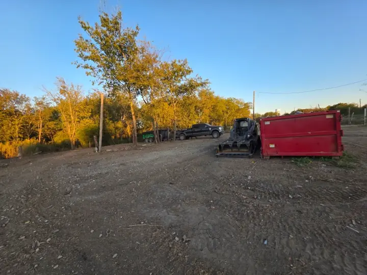 Cleared lot after debris removal at sunset