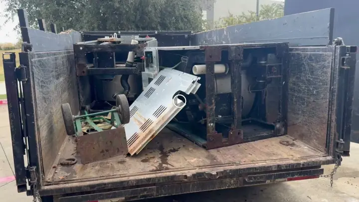 Dump trailer loaded with old equipment from a business cleanout